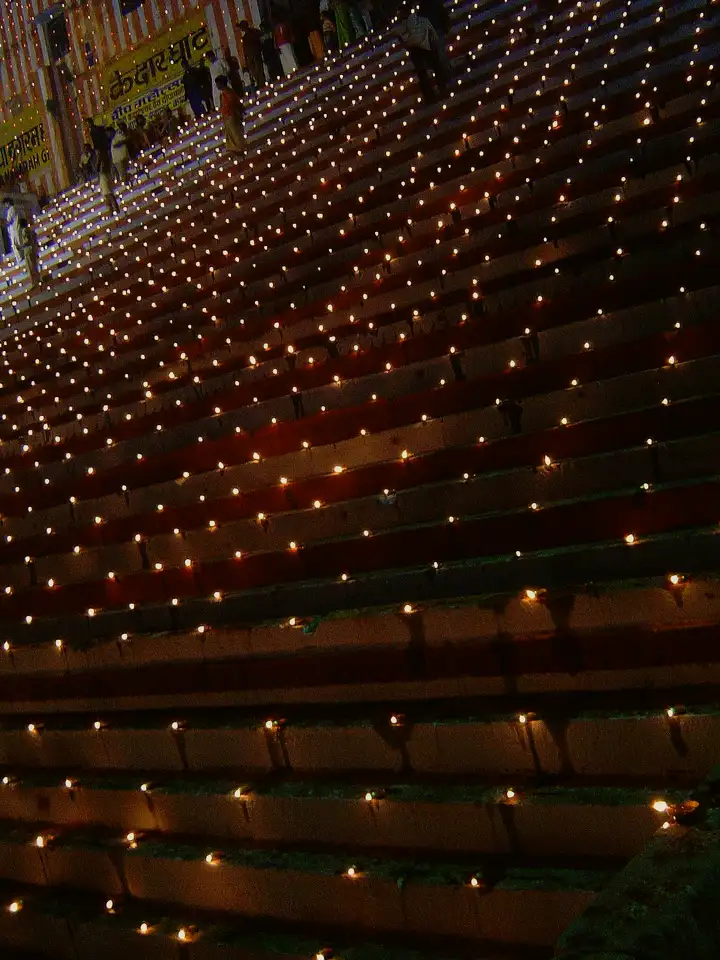 Rows of oil lamps lit on the ghat steps for Dev Deepawali
