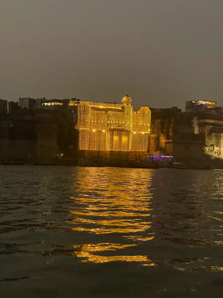 Darbhanga Palace strung with lights for Diwali, seen from the Ganga