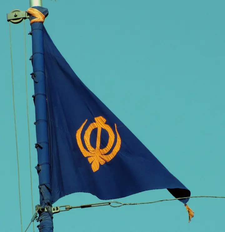 A blue Nishan Sahib bearing the Khanda at Baba Phoola Singh di Burj, Amritsar (not taken in Varanasi)