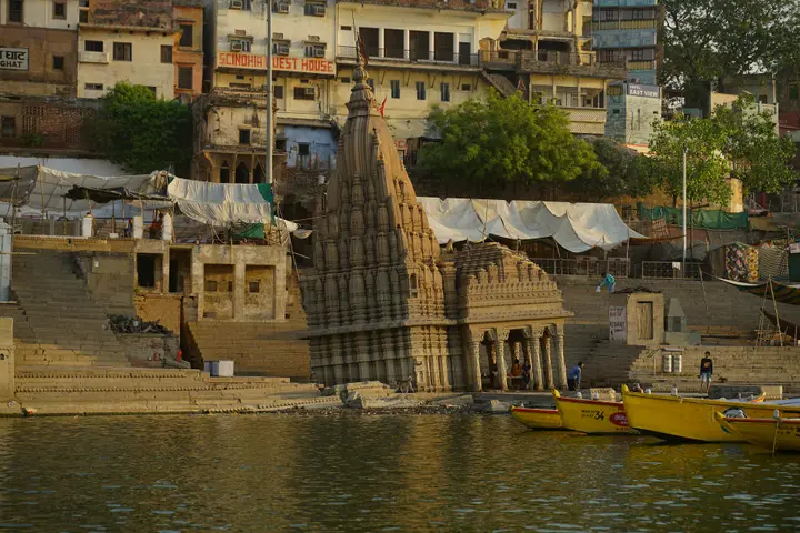 The leaning Ratneshwar Mahadev temple at Scindia Ghat, seen from the river